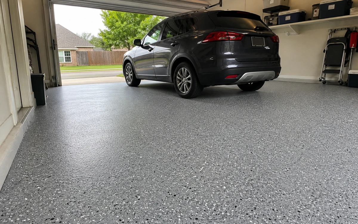 Finished polyaspartic flake floor in a garage with a parked vehicle